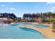 Beautiful community pool with several pools, sunning deck, and lush landscaping with a view of the clubhouse at 493 Spanish Wells Rd, Summerville, SC 29486