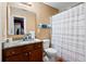 Traditional bathroom with granite countertops, vanity, toilet, and shower with striped shower curtain at 4938 Ballantine Dr, Summerville, SC 29485