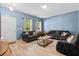 Bright living room featuring hardwood floors, comfortable seating, and an abundance of natural light at 4938 Ballantine Dr, Summerville, SC 29485