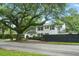 Charming two-story home with black shutters and mature tree in the front yard at 51 Stocker Dr, Charleston, SC 29407