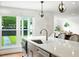 Kitchen island with stainless steel sink and view to backyard at 51 Stocker Dr, Charleston, SC 29407
