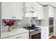 Modern kitchen with white cabinets, gray backsplash, stainless steel appliances, and quartz countertops at 51 Stocker Dr, Charleston, SC 29407