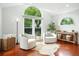 Living area featuring large windows, hardwood floors, accent chairs, and decorative decor at 51 Stocker Dr, Charleston, SC 29407