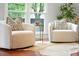 Bright living area with two comfortable chairs, decorative pillows, hardwood floors, and a large window at 51 Stocker Dr, Charleston, SC 29407