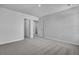 Neutral bedroom showcasing modern carpet and trim with access to hallway and closet with open doors at 542 Verdi Dr, Summerville, SC 29486