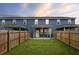 A fenced backyard features lush green grass and patio, perfect for outdoor entertaining and privacy at 5133 Park Creek Ave, North Charleston, SC 29418