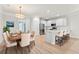 Open kitchen with white cabinets, stainless steel appliances and breakfast bar integrated into the dining area at 5133 Park Creek Ave, North Charleston, SC 29418
