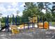 Colorful community playground equipment with slides, climbing structures, and swings for to enjoy at 5133 Park Creek Ave, North Charleston, SC 29418