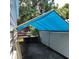 Carport featuring a blue awning with an adjacent work area and boat at 5209 Sterrett St, North Charleston, SC 29405