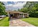 Charming brick home with a covered parking area and well-manicured lawn, enhancing curb appeal at 5209 Sterrett St, North Charleston, SC 29405