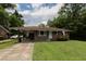 Charming brick home with a covered carport, mature trees, and a well-maintained front lawn at 5209 Sterrett St, North Charleston, SC 29405