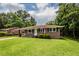 Inviting brick home featuring a well-maintained lawn, and classic architectural details at 5209 Sterrett St, North Charleston, SC 29405