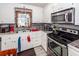 Well-lit kitchen featuring granite counters, stainless steel appliances, and ample cabinet space at 5209 Sterrett St, North Charleston, SC 29405