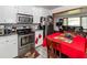 Kitchen area with stainless steel appliances and a table with a red tablecloth at 5209 Sterrett St, North Charleston, SC 29405
