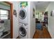 Hallway laundry with stackable washer/dryer and access to the bathroom at 5209 Sterrett St, North Charleston, SC 29405