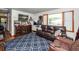 Cozy living room with a large window, comfortable seating, and a patterned blue rug at 5209 Sterrett St, North Charleston, SC 29405