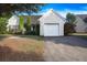 Single-story home featuring an attached garage, manicured lawn, and quaint landscaping at 5217 Copley Cir, Summerville, SC 29485