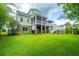 Expansive backyard featuring a lush lawn, screened porch, and tiered deck perfect for outdoor gatherings at 544 Two Mile Run, Johns Island, SC 29455