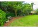 Well-maintained backyard with lawn, flower bushes, and shade trees, offering a peaceful retreat at 544 Two Mile Run, Johns Island, SC 29455