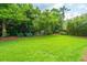 A backyard view with a black fence, lush greenery, and well-manicured lawn at 544 Two Mile Run, Johns Island, SC 29455