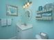 Bright bathroom with white vanity, round mirror, and coastal-themed decor for a fresh feel at 544 Two Mile Run, Johns Island, SC 29455