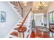 Elegant foyer with wood floors, staircase, stylish chandelier, and ample natural light, creating a welcoming entrance at 544 Two Mile Run, Johns Island, SC 29455