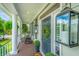 Inviting front porch with comfortable seating, stylish decor, and classic lanterns, offering a relaxing outdoor space at 544 Two Mile Run, Johns Island, SC 29455