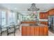 Bright open kitchen with granite counters, central island, stainless appliances, and dining area at 544 Two Mile Run, Johns Island, SC 29455