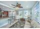 Open-concept living space featuring a sunroom area with tan sofa, tile flooring, and breakfast bar seating at 544 Two Mile Run, Johns Island, SC 29455
