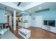 Living room with wood floors, a gray sofa, and kitchen access at 544 Two Mile Run, Johns Island, SC 29455