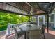 Comfortable deck with outdoor dining table, seating, and a view of the lush surroundings at 544 Two Mile Run, Johns Island, SC 29455