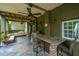 Enjoy outdoor living with this patio, featuring a bar, grill, seating, and ceiling fans at 544 Two Mile Run, Johns Island, SC 29455