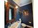 Stylish powder room with a decorative mirror, vanity with a vessel sink, and elegant wall sconces at 544 Two Mile Run, Johns Island, SC 29455