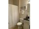 Cozy bathroom with toilet, shower with white curtain, and vanity with black countertop at 556 Sea Foam St, Summerville, SC 29486