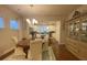Dining room features a wood table, china cabinet, and a view into the bright kitchen at 556 Sea Foam St, Summerville, SC 29486