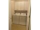 Well-lit laundry room with white washer, dryer and white cabinets at 556 Sea Foam St, Summerville, SC 29486