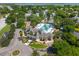 Aerial view of community pool, clubhouse, and landscaping featuring well-maintained grounds and a pond at 591 Island Walk East, Mount Pleasant, SC 29464