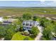 Stunning aerial view of a waterfront home with lush landscaping and a serene marsh backdrop at 591 Island Walk East, Mount Pleasant, SC 29464
