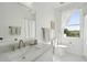 Bright bathroom featuring a window, stylish fixtures, patterned tile floor, and a serene view at 591 Island Walk East, Mount Pleasant, SC 29464