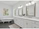 Bright bathroom featuring a soaking tub, double vanity with marble counters, and modern fixtures at 591 Island Walk East, Mount Pleasant, SC 29464