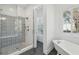 Elegant bathroom featuring a glass shower, white subway tiles, decorative patterned floor, and soaking tub at 591 Island Walk East, Mount Pleasant, SC 29464