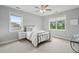 Cozy bedroom with large windows, neutral carpet, and a black iron bed frame at 591 Island Walk East, Mount Pleasant, SC 29464