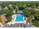 Aerial view of community pool surrounded by lush landscaping and lounge chairs on a sunny day at 591 Island Walk East, Mount Pleasant, SC 29464