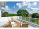 Spacious deck with wicker furniture, white railings, and scenic treetop views beyond at 591 Island Walk East, Mount Pleasant, SC 29464