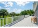 Spacious deck area overlooking mature trees, lush green grass, and in-ground swimming pool at 591 Island Walk East, Mount Pleasant, SC 29464