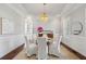 Elegant dining room featuring a round table, chandelier, wainscoting, and ample natural light at 591 Island Walk East, Mount Pleasant, SC 29464