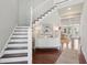 Inviting foyer with staircase, hardwood floors, stylish console table, and seamless access to other living areas at 591 Island Walk East, Mount Pleasant, SC 29464