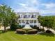 Charming two-story home with a manicured lawn, inviting porch, and classic architectural details at 591 Island Walk East, Mount Pleasant, SC 29464