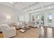 Bright living room with coffered ceilings, hardwood floors, and seamless transition to outdoor patio at 591 Island Walk East, Mount Pleasant, SC 29464