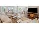 Spacious living room with hardwood floors, comfortable seating, and backyard views, perfect for gatherings at 591 Island Walk East, Mount Pleasant, SC 29464